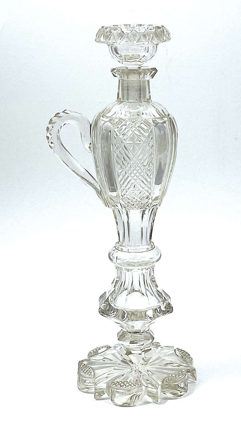 Large Antique Cut Crystal Bottle with Applied Handle and Faceted Foot.