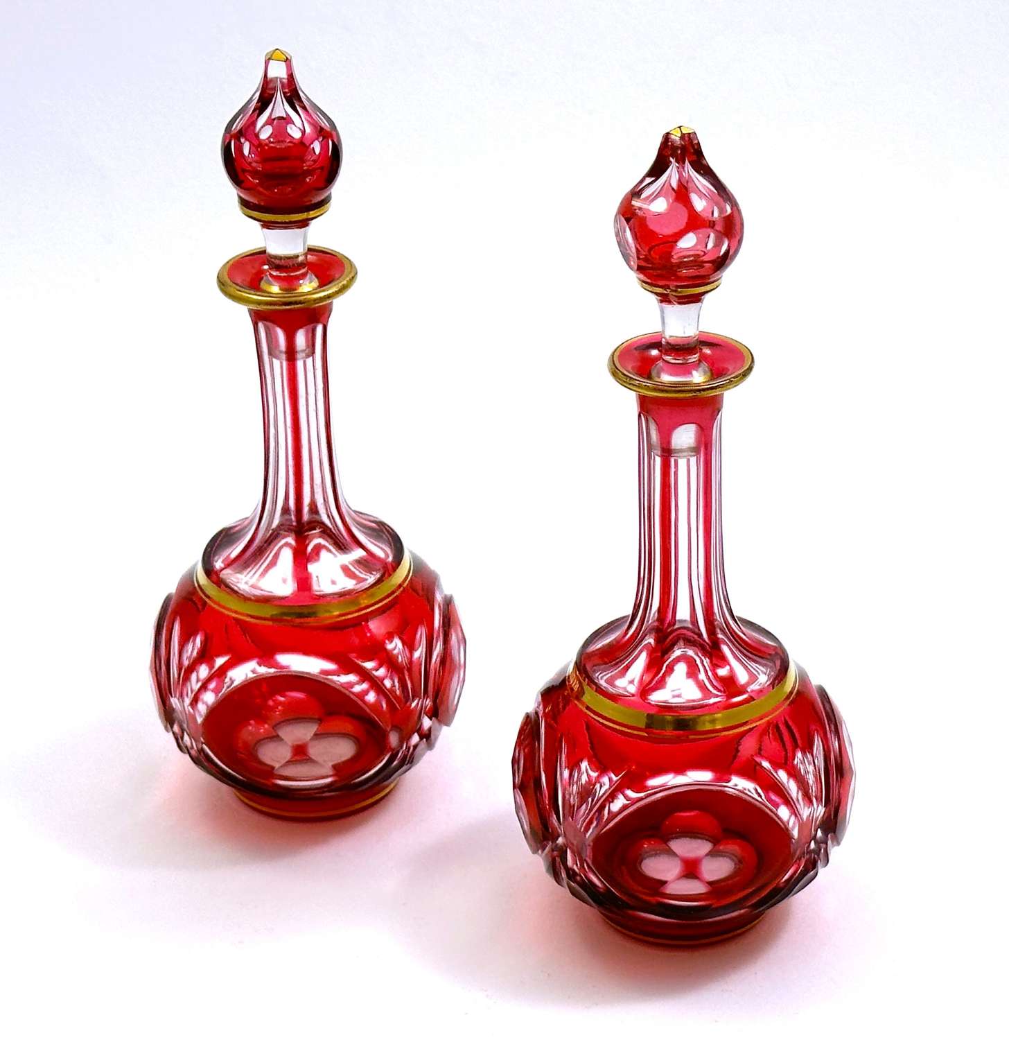 A Pair of Antique French Cranberry and Clear Overlay Perfume Bottles